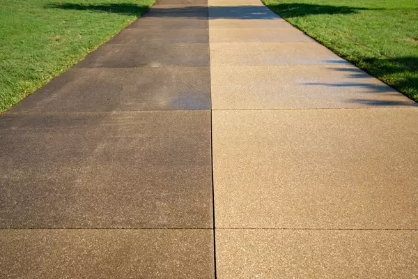 Before and after of pressure washed driveway